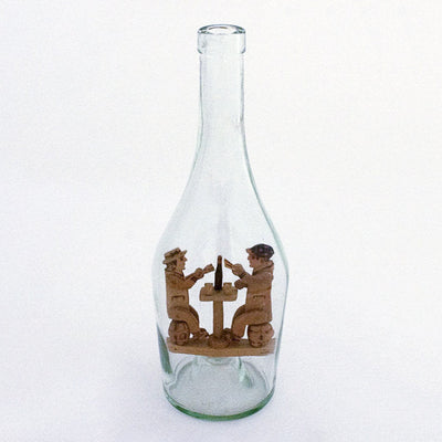 Articulated wood carved card players in a bottle. 