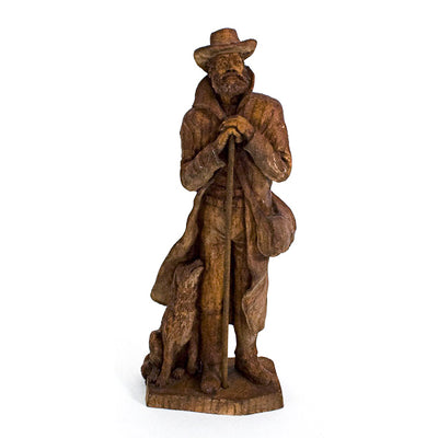 Wood carving of a frontiersman and his dog.