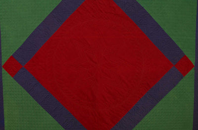 Close up of red diamond in square pattern on Lancaster County Amish Diamond in Square Quilt.