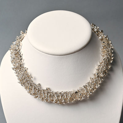 Tane Sterling Silver "Sprinkles" Necklace with hundreds of silver nailheads affixed to each other.
