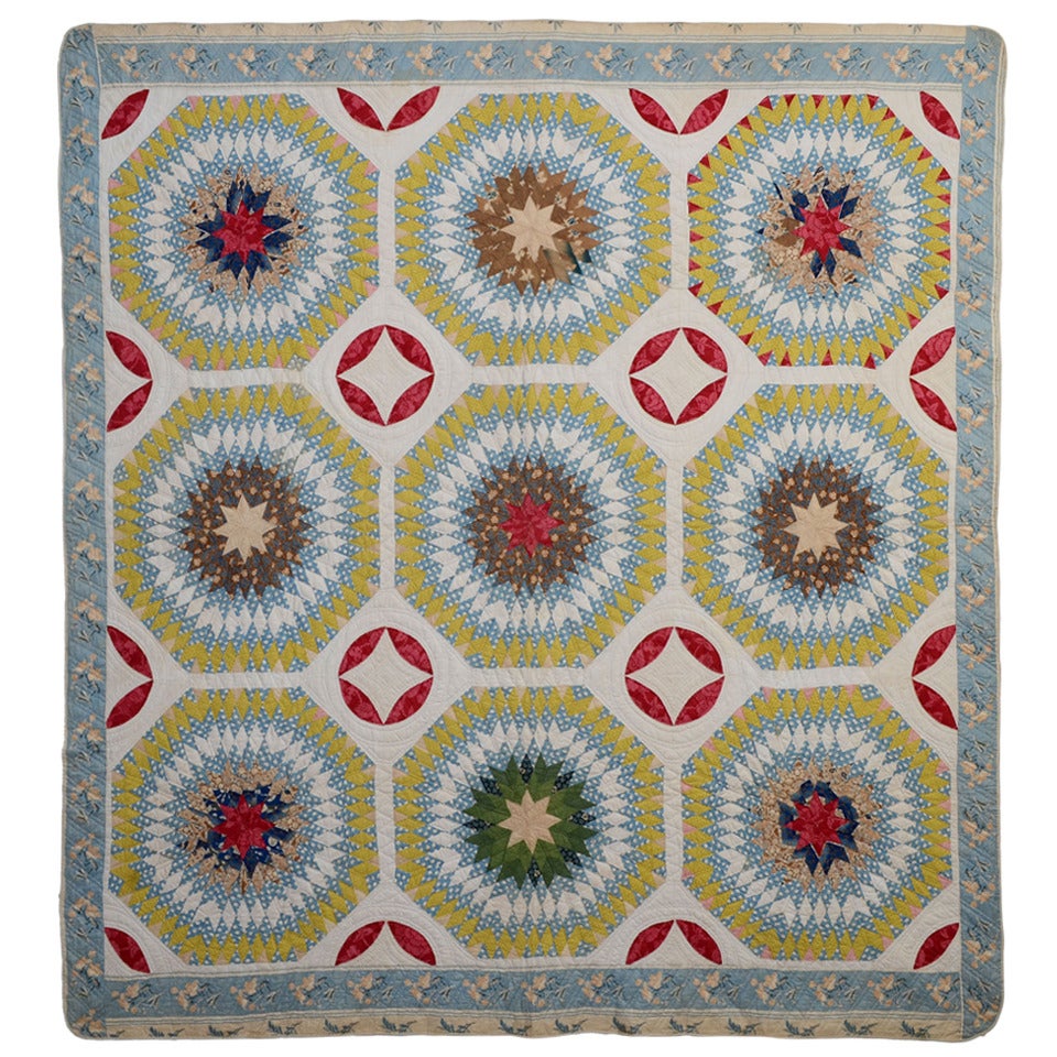 Light blue, yellow and red "Starbursts Quilt Circa 1850" front view.