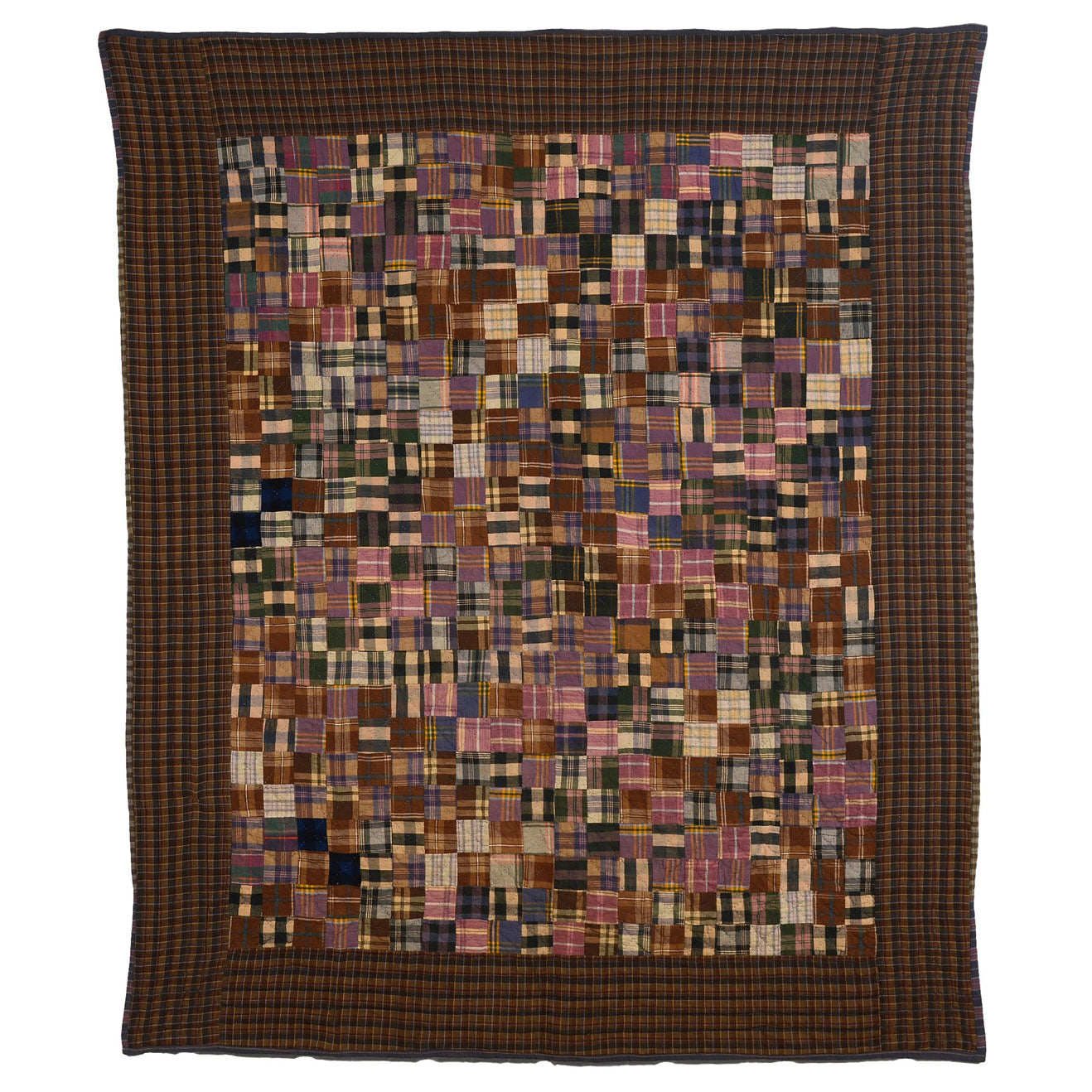 Brown plaid antique quilt with patches of pinks and browns throughout the center.