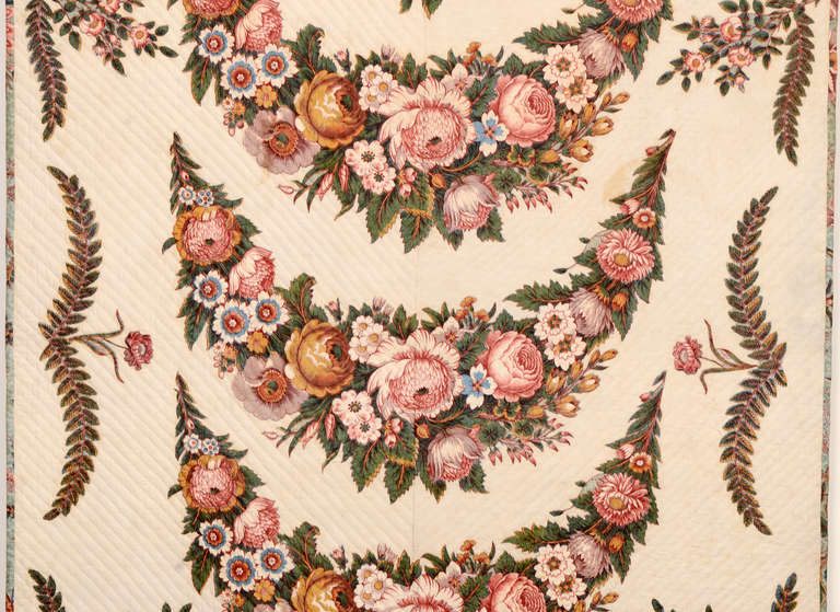 Middle view of antique quilt showing flowers. 