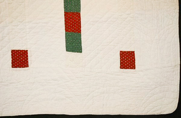 White quilt corner detail shot showing red and green squares with white polkadots.