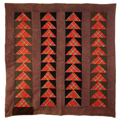 Antique "Wild Goose Chase Quilt" with a brown base, red triangles on black and green stripes. 