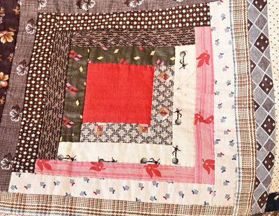 Fabric patch showing stitching details and fabrics used on a 19th century Barn-raising Log Cabin Quilt.