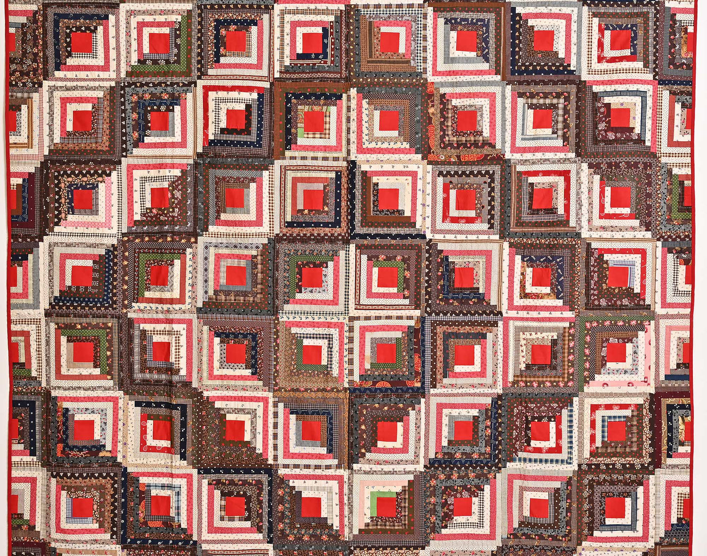Central view of diamond shapes in the center of 19th century Barn-raising Log Cabin Quilt from the 19th century.