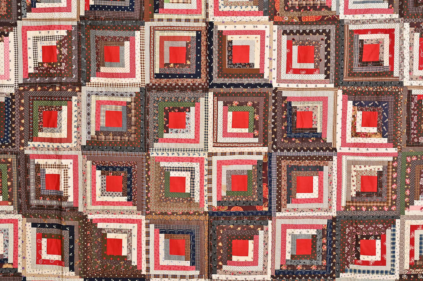 Close up of diamond and square patterns on 19th century Barn-raising Log Cabin Quilt.