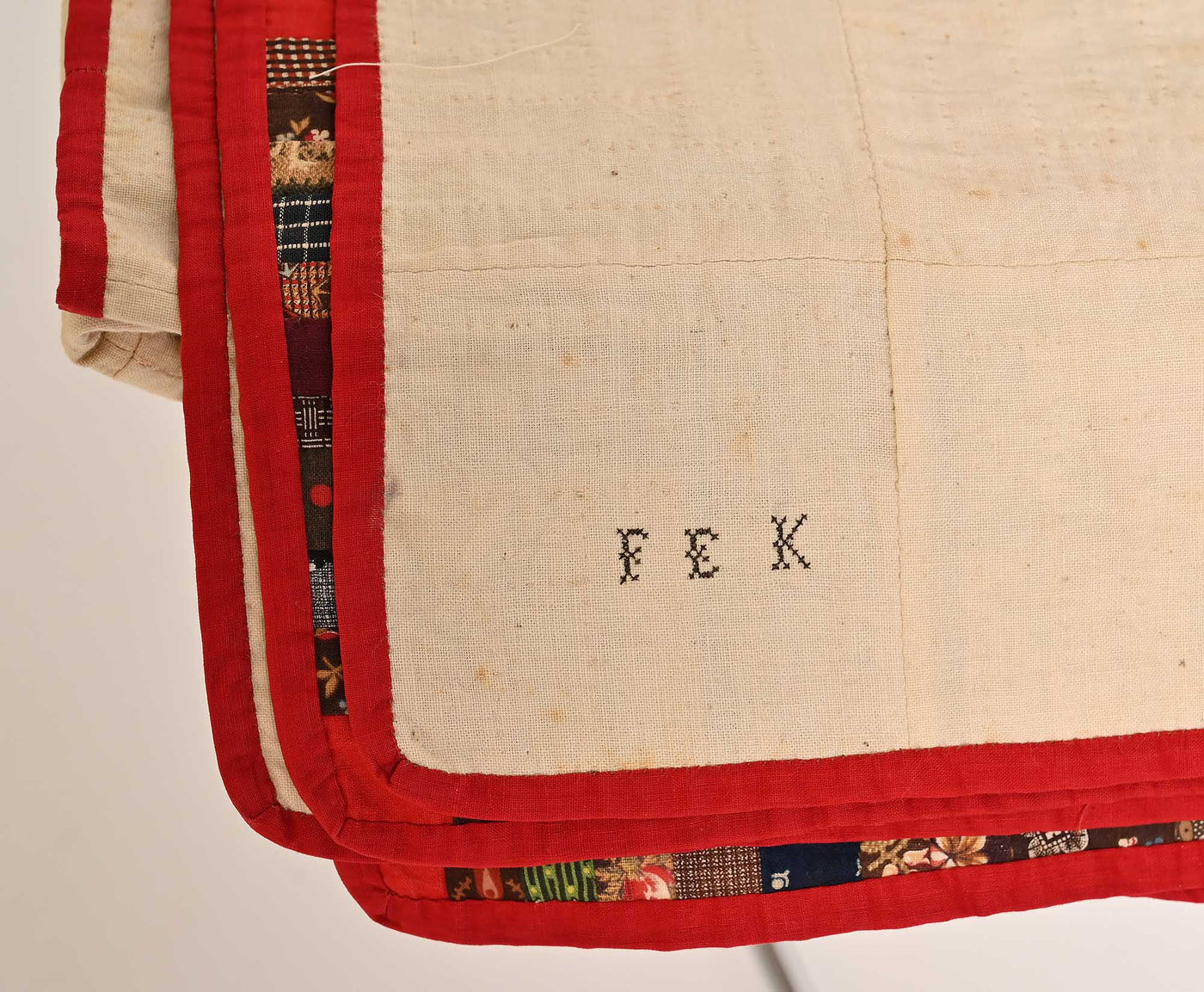 Backing of 19th century Barn-raising Log Cabin Quilt showing intials "F.E.K"