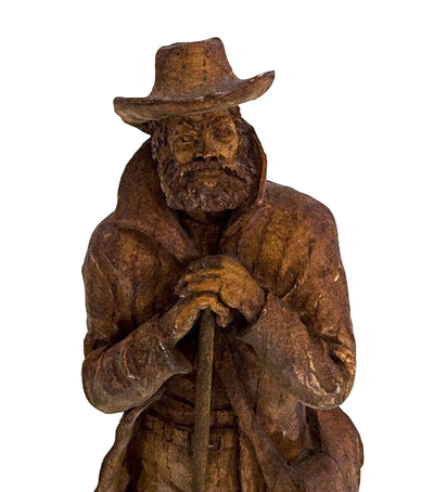 Close up of wood carving of a frontiersman.