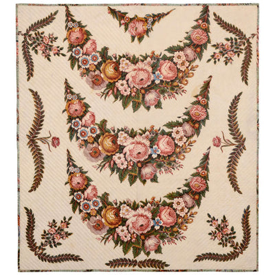 Tan colored chintz Broderie Perse Crib Quilt from the 19th century with  pink and orange flowers.