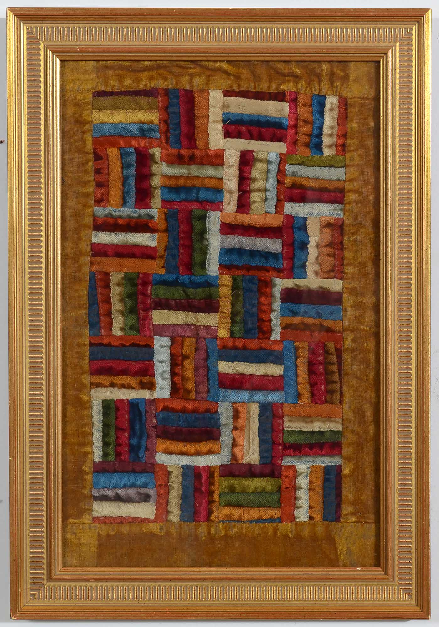 Fence Rail Log Cabin doll quilt made of richly colored plush velvets in a gold leaf frame measuring 13 3/4" x 20". 