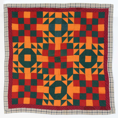 Full size view of19th century Georgetown Circle Crib Quilt with a combination of red, orange and green patterns. 