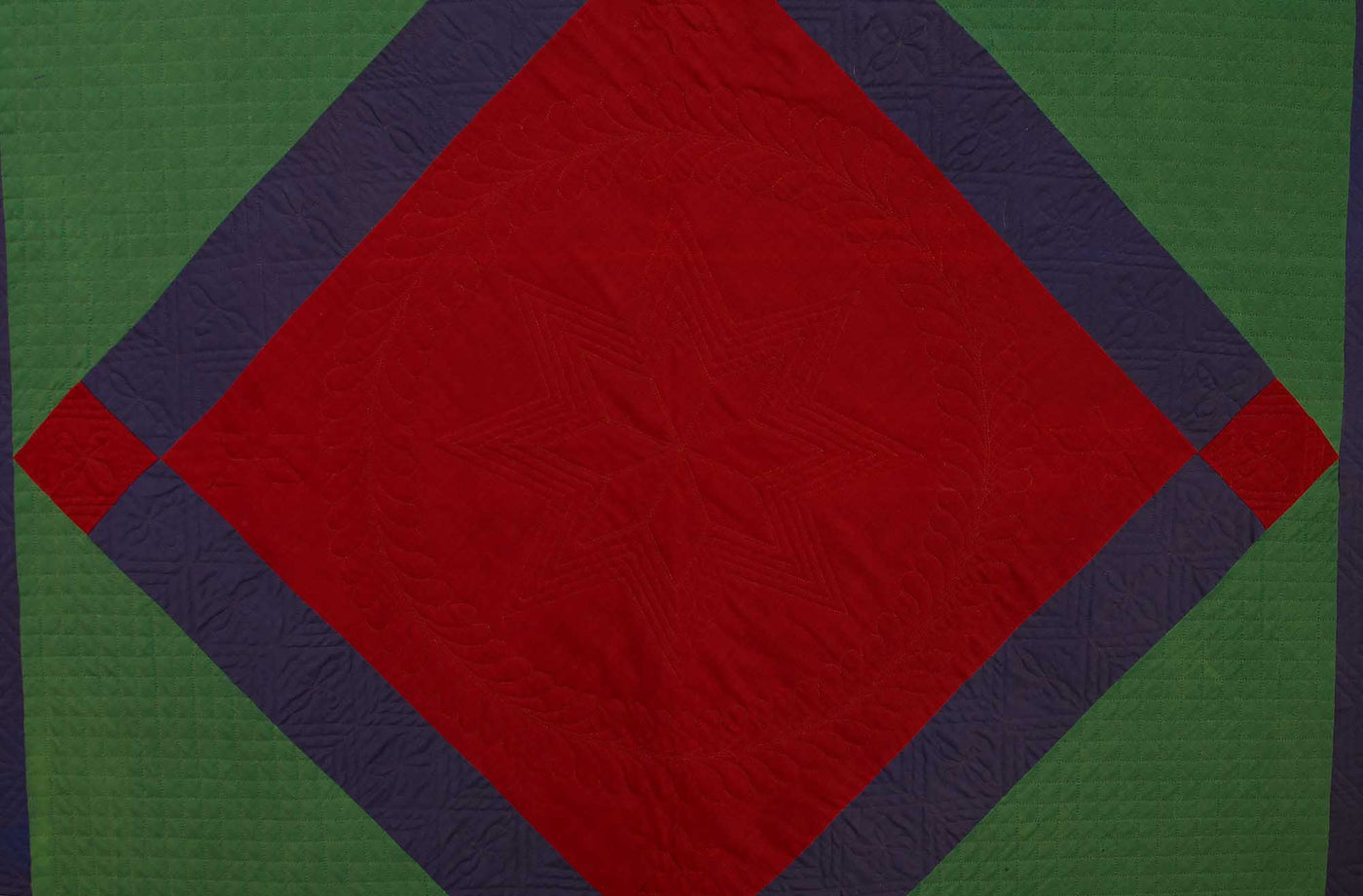Close up of red diamond in square pattern on Lancaster County Amish Diamond in Square Quilt.