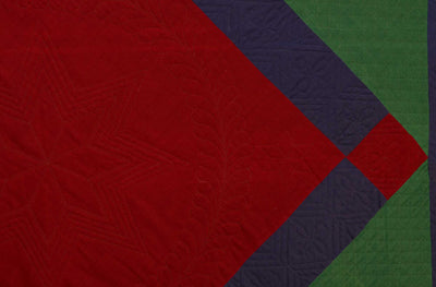 Close up Lancaster County Amish Diamond in Square Quilt showing purple border around red diamond pattern.