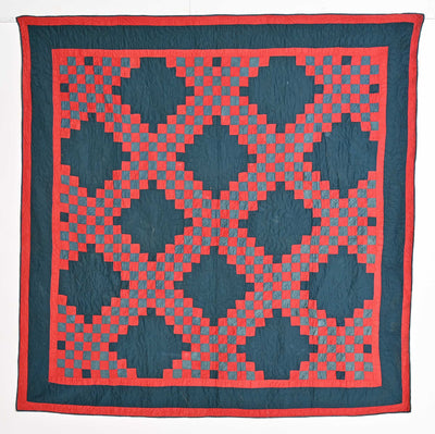 Antique Mennonite Irish Chain quilt done in solid colors of red and two tones of dark blue.