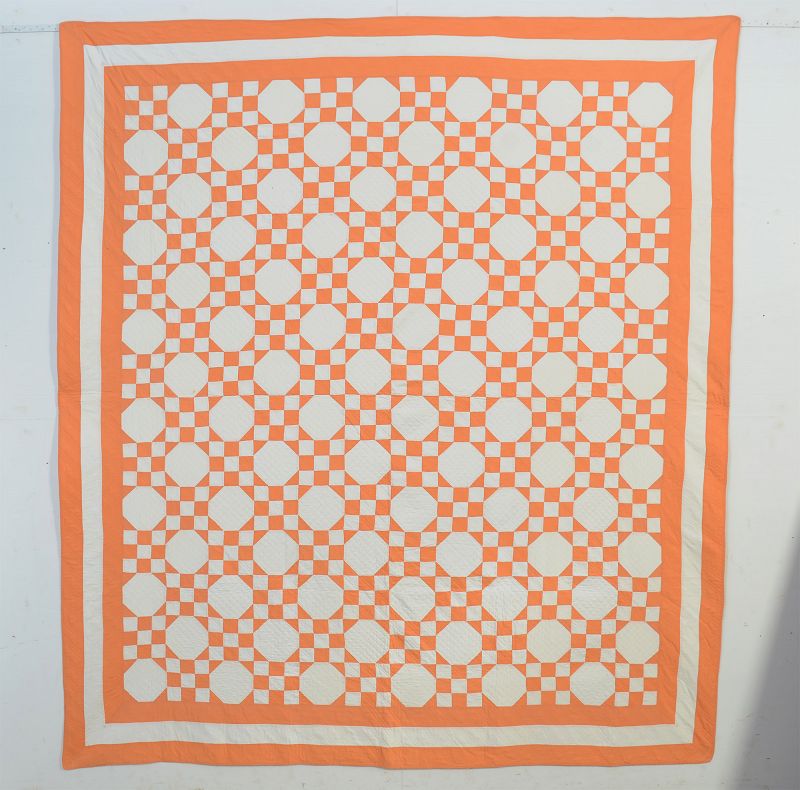 Peach and white Nine Patch and Octagons quilt from the 20th century. Maryland origin.