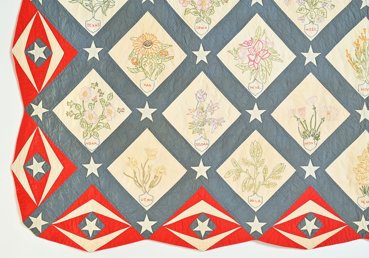 Bottom left corner of patriotic quilt with state flowers. 