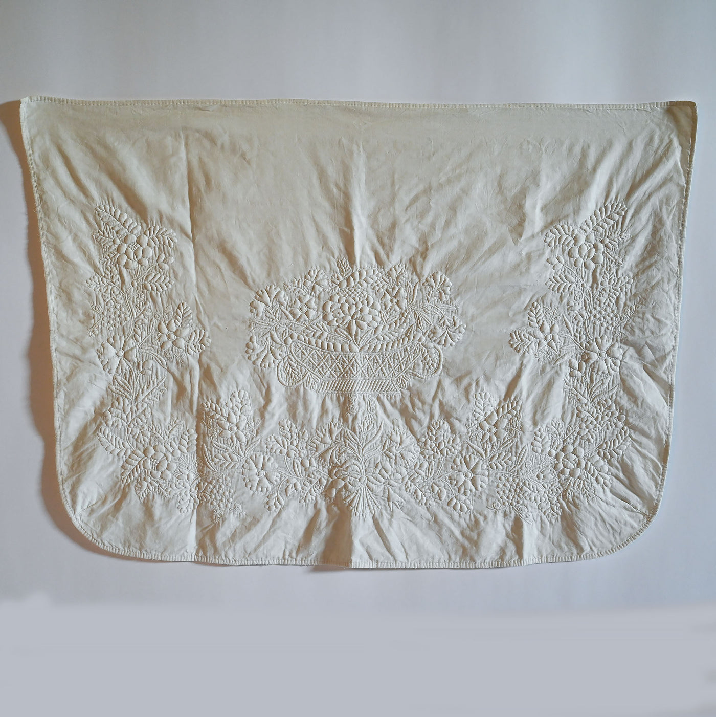 Large white antique trapunto dresser scarf from the 1800's.